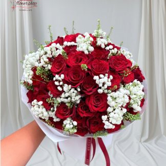 bouquet of red roses mixed with white baby's breath