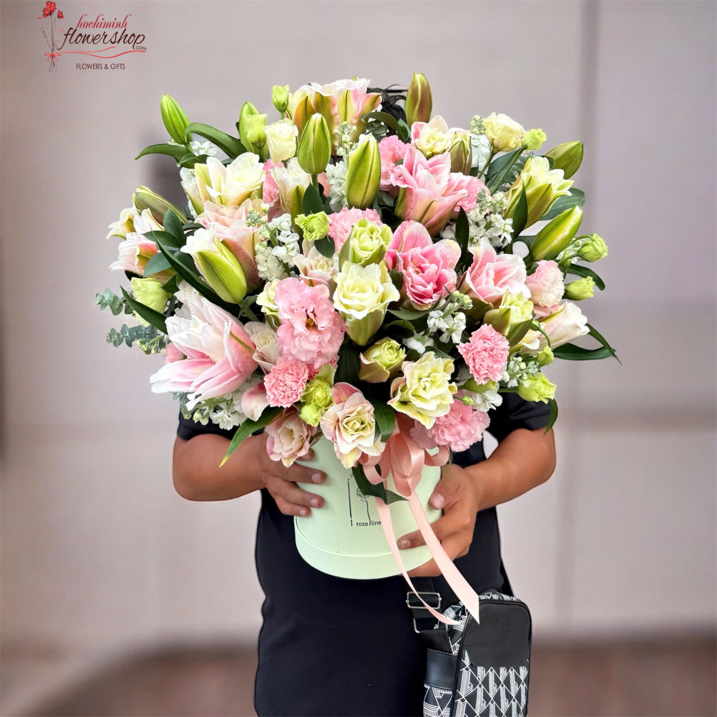 flower basket combining pink lilies and carnations