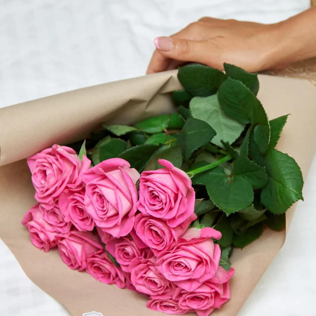 Fresh flower bouquet in wrapping paper after delivery, ready for unpacking
