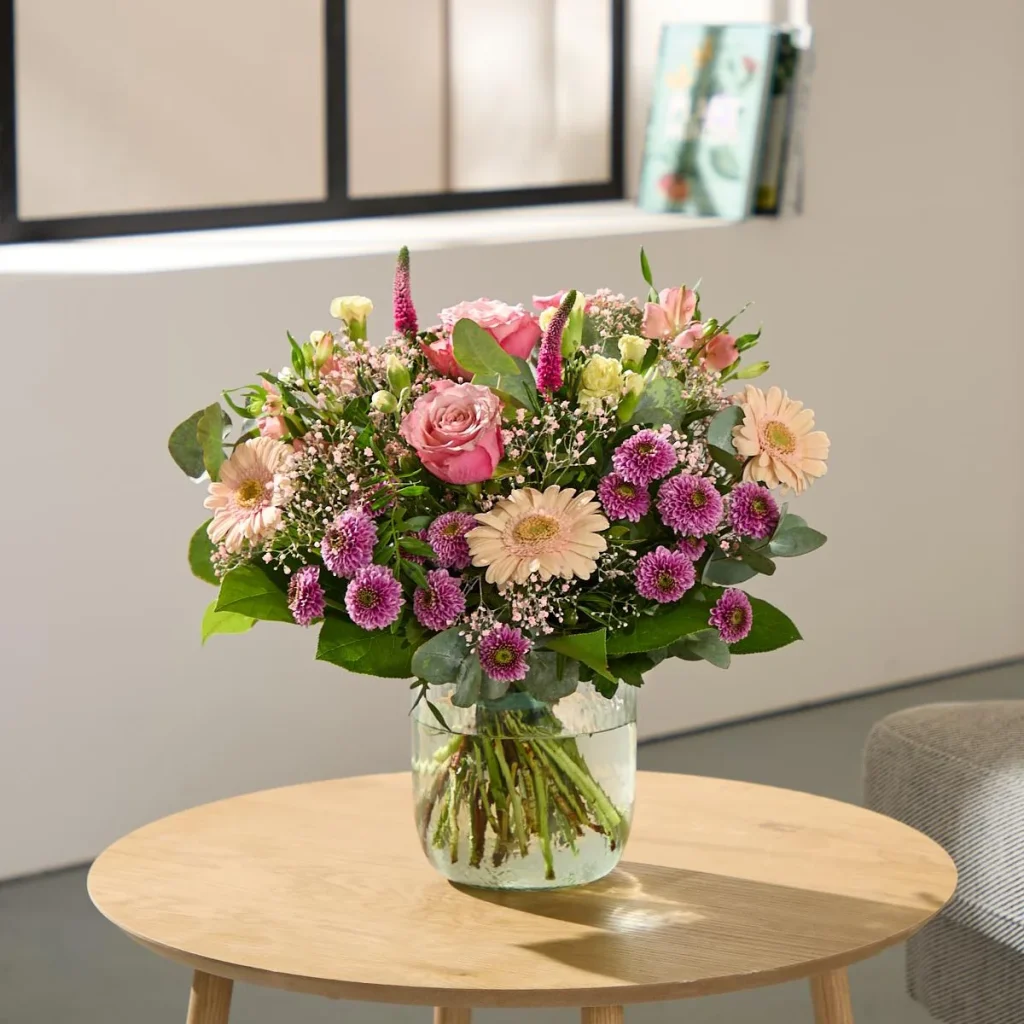 Fresh flower bouquet arranged in a glass vase with clean water
